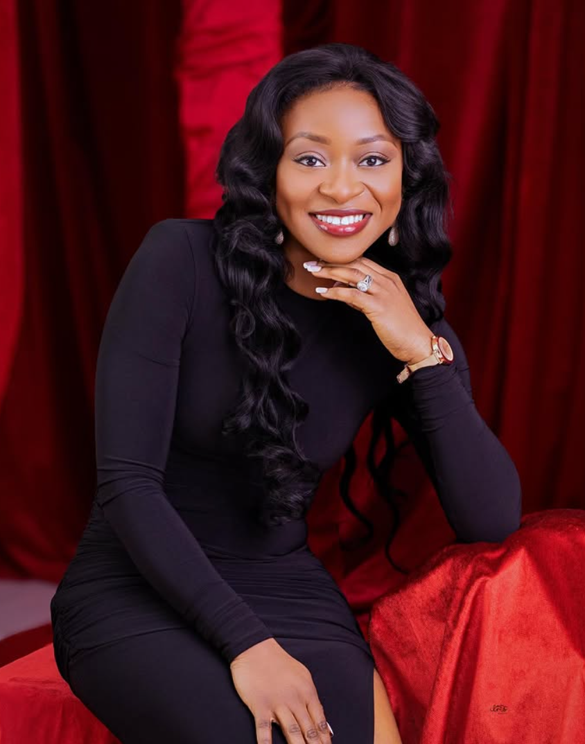 Elegant portrait of a woman in black against a red velvet backdrop
