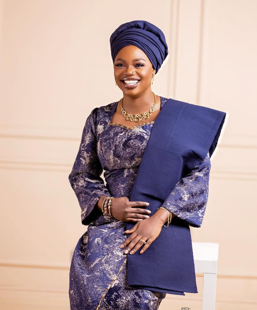 Traditional attire portrait with gele headwrap against a soft cream set